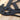 Close up of pilot family name metal sign with propeller, in matte black powder coat.