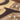 Close up of copper vein powder coat on our ampersand metal wall decor.