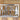 Close up of pine trees on our rectangular home name metal sign, in raw steel.
