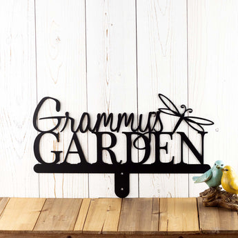 Hanging metal garden name sign in matte black powder coat, with a dragonfly