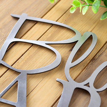 Close up of raw steel on our garden name metal sign.