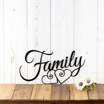 Family script metal wall art with two hearts, in matte black powder coat.