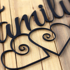 Close up of matte black powder coat on our family metal sign with hearts. 