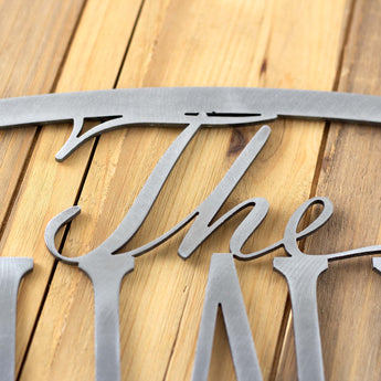 Close raw steel on our oval outdoor metal family name sign.