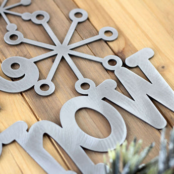 Close up of raw steel on our Let it Snow metal wall art.