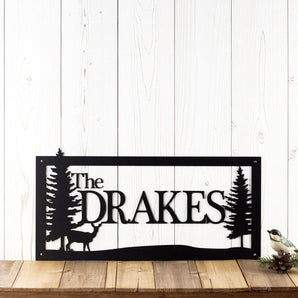 Rectangular family name metal sign with a doe deer and pine trees, in matte black powder coat.