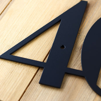 Close up of matte black powder coat on our modern metal house number sign.