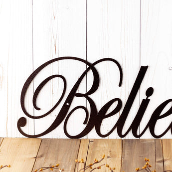 Close up of believe metal wall decor with script lettering, in copper vein powder coat.