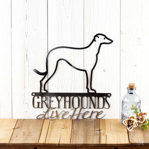 Greyhounds Live Here metal wall art, with Greyhound dog silhouette, in raw steel. 