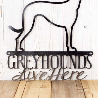 Close up of Greyhounds Live Here wording on our Greyhound dog metal sign, in raw steel.