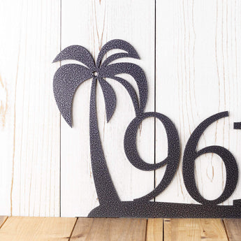 Close up of palm tree on our metal address plaque, in silver vein powder coat.