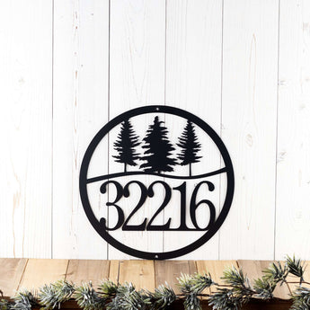 Circular hanging metal house number sign with pine trree silhouettes, in matte black powder coat.