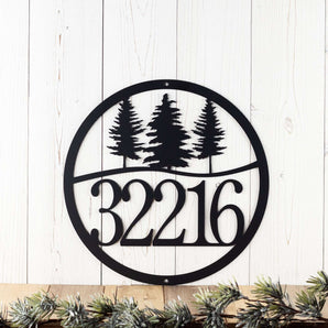 Round metal house number sign with pine trees, in matte black powder coat.