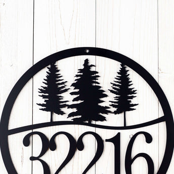 Close up of pine trees on our 5 digit metal address sign, in matte black powder coat.