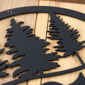 Close up of matte black powder coat on our metal house number sign with pine trees.