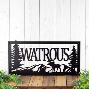 Rectangular metal family name sign with moose and mountains, in matte black powder coat.