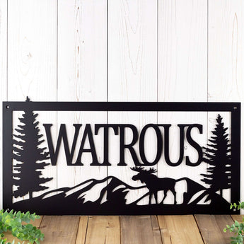 Metal family last name plaque with moose and mountains, in matte black powder coat.