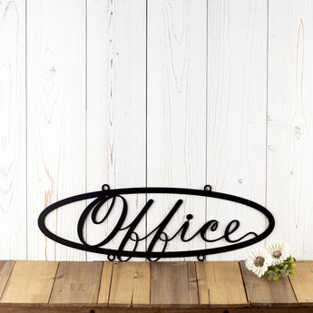 Hanging oval office metal sign with script lettering, in matte black powder coat.