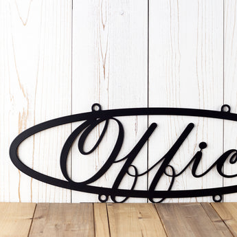 Close up of script lettering on our hanging oval office metal sign, in matte black powder coat.