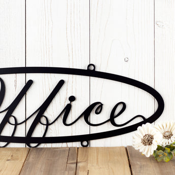 Close up of cursive lettering on our hanging oval office metal sign, in matte black powder coat.