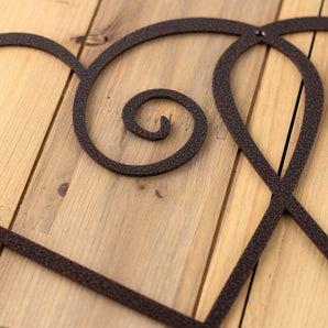 Close up of copper vein powder coat on our curly hearts metal sign.