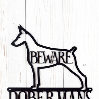 Close up of Doberman Pinscher silhouette, with Beware, on our Doberman metal sign, in matte black powder coat.