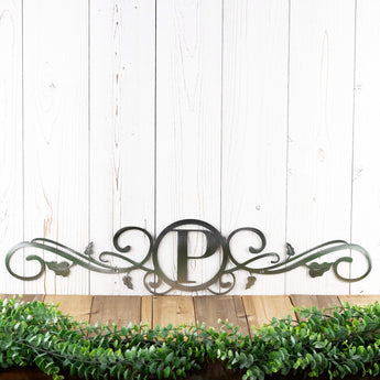 Metal monogram sign with vines, in raw steel. 