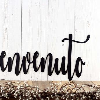 Close up of cursive lettering on our Benvenuto Italian welcome metal sign, in matte black powder coat.