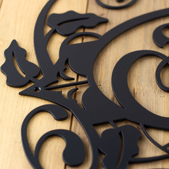 Close up of matte black powder coat on our metal monogram sign.