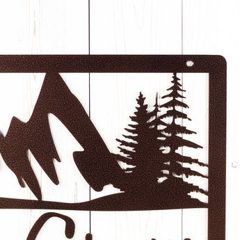 Close up of mountains and trees on our rectangular custom metal sign, in copper vein powder coat.