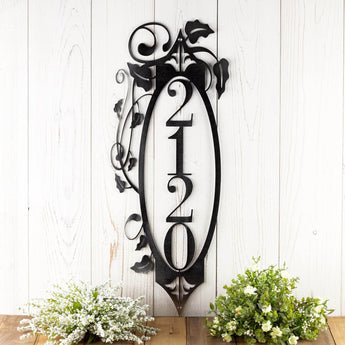 4 digit vertical metal house number sign with vines and fleur de lis, in raw steel. 