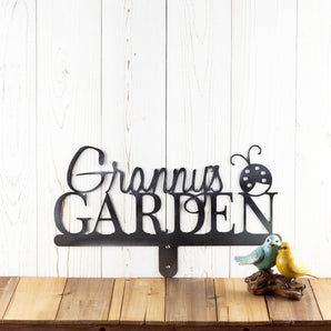 Metal garden sign with first name and ladybug image, in raw steel.