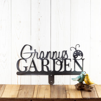 Garden metal name sign with a lady bug silhouette, in raw steel.