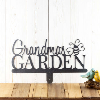 Garden name metal yard sign, with a bumble bee silhouette, in silver vein. 