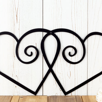 Close up of heart metal sign with swirl, in matte black powder coat.