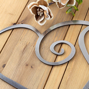 Close up of raw steel on our curly hearts metal sign.