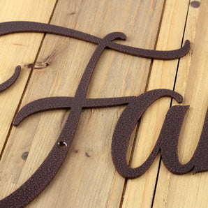 Close up of copper vein powder coat on our Family script metal sign.