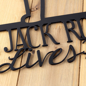 Close up of matte black powder coat on our Jack Russell lives here metal sign.