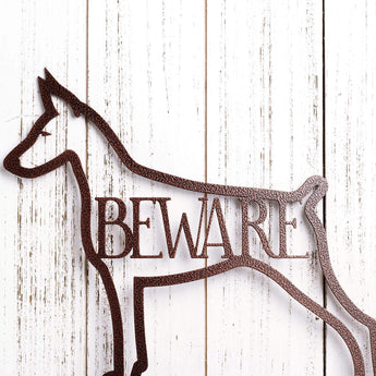 Close up of Doberman Pinscher silhouette, with Beware, on our Doberman metal sign, in copper vein powder coat. 