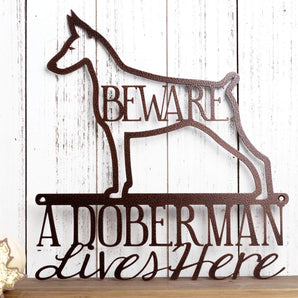 A Doberman Lives Here metal wall art, with Beware, in copper vein powder coat. 