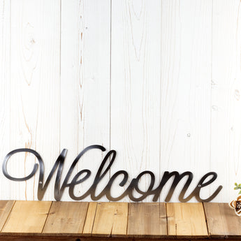 Welcome script metal sign, in raw steel.