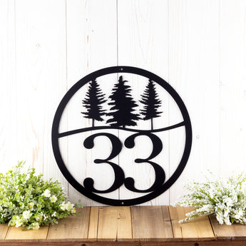 Round metal house number sign with pine trees, in matte black powder coat.