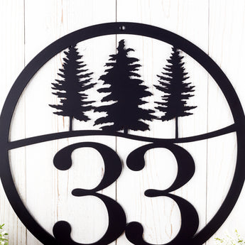 Close up of pine trees on our 2 digit metal address sign, in matte black powder coat.