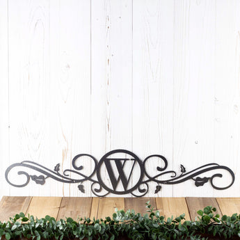 Metal monogram sign with scrollwork and vines, in silver vein powder coat.