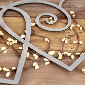 Close up of raw steel on our curly hearts metal sign.
