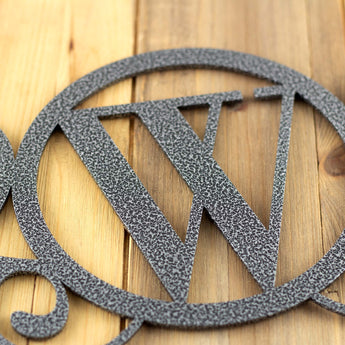 Close up of silver vein powder coat on our monogram metal sign.