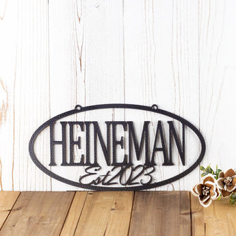 Hanging oval custom family name and established year metal sign, in silver vein powder coat.