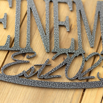 Close up of silver vein powder coat on our oval personalized family name sign. 