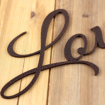 Close up of Love script metal sign, in copper vein powder coat.