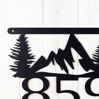 Close up of our 3 digit mountain metal house number sign, in matte black powder coat.